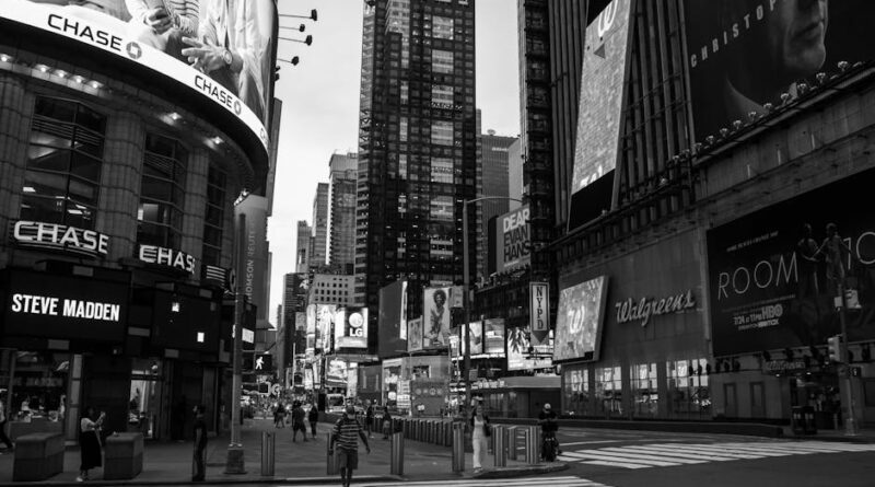 Black and white photo of Times Square, New York City, showcasing iconic billboards and urban vibe.